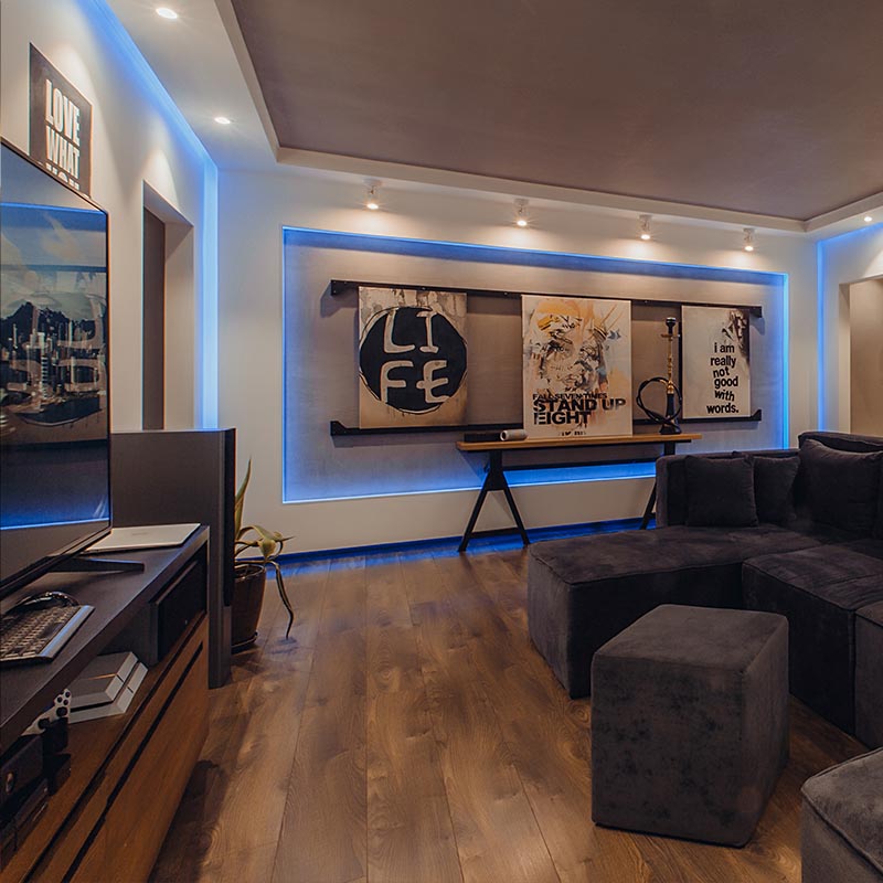 contact lopez design and drafting services. Basement renovation with home theater by Lopez Design and Drafting Services: A cozy and immersive entertainment area with plush seating, a large screen, and sound system.